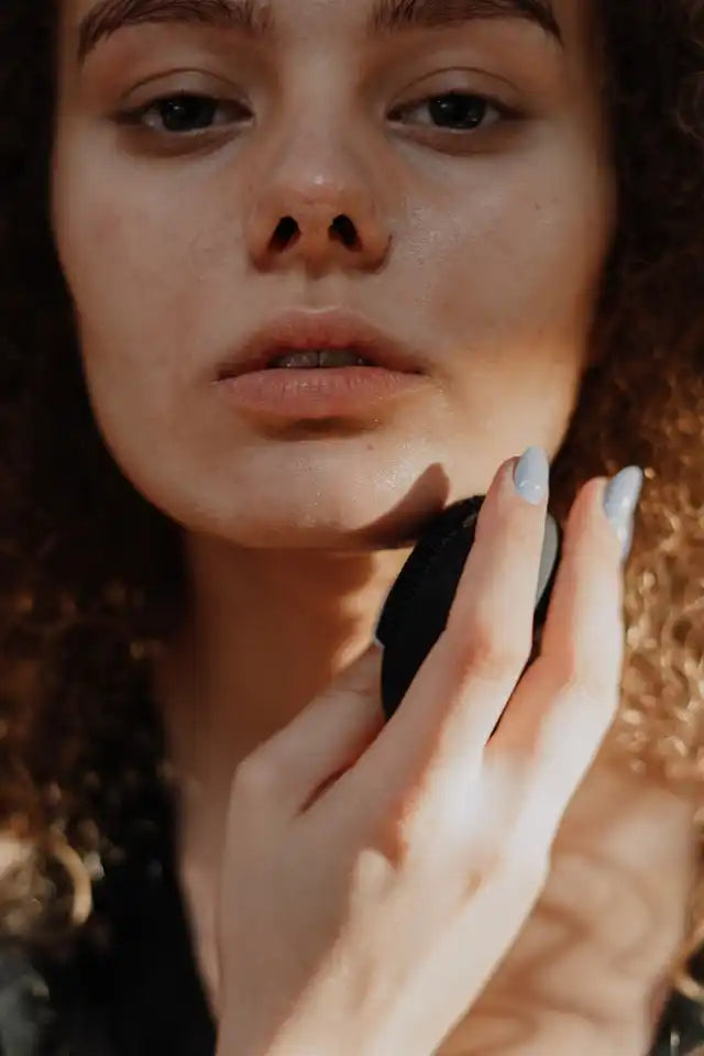 Woman applying makeup.